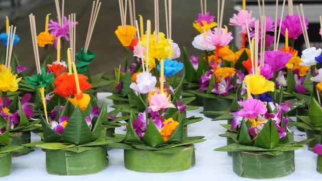 Paper lotus flower with candle floating on a river at night in Loy krathong festival, traditional Siamese new year festival celebrated in Thailand.