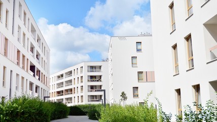 Modern multi-storey luxury housing concept. Modern apartment building with blue sky and clouds.