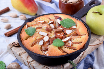 Pie with pears, apples and almonds in a little cast iron pan