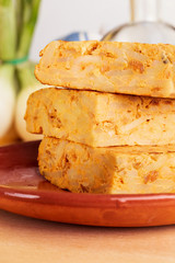 Close-up of portions of homemade (Spanish) potato omelette with natural ingredients (fresh eggs, olive oil, potatoes, onion, chorizo)