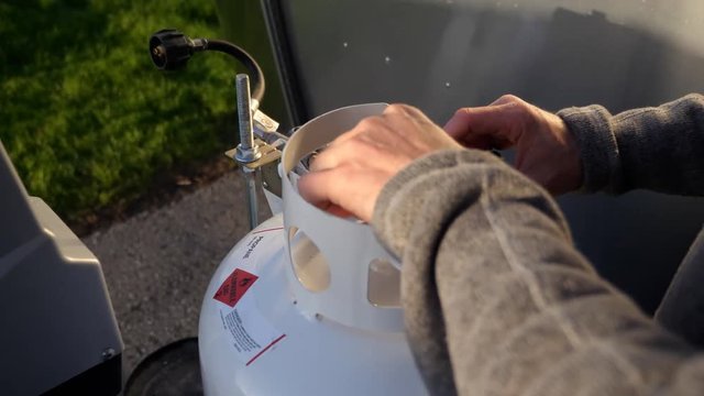 Close up installing propane tanks on RV for camping