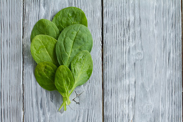 close - up of spinach sheets on wooden background