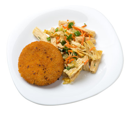 fishcake with soy asparagus and carrots, cucumbers and dilll.  fish cutlet on a plate isolated. cutlet with vegetables top view