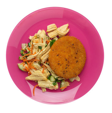 fishcake with soy asparagus and carrots, cucumbers and dilll.  fish cutlet on a plate isolated. cutlet with vegetables top view