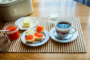 Breakfast,  Cup of coffee and a sandwich with red caviar