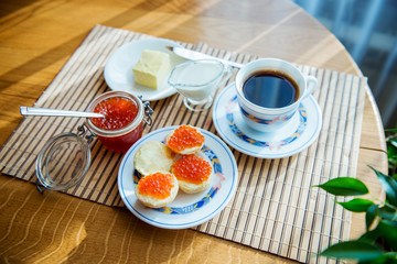 Breakfast,  Cup of coffee and a sandwich with red caviar