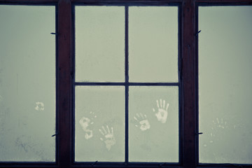Window in the room covered with frosty mosaic in winter. Frost patterns on glass