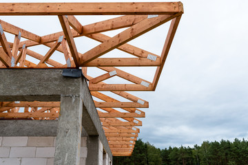 Roof trusses not covered with ceramic tile on a detached house under construction, visible roof elements, battens, counter battens, rafters.