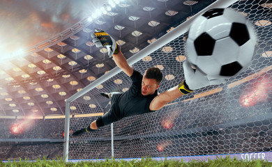Soccer players in action on professional stadium on sunset.