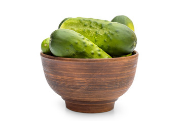 Bowl with cucumbers on white background.
