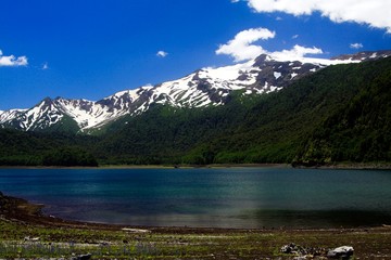 Volcano Llaima at Conguillio NP in central Chile - View over the lake on black peak with isolated spots of snow