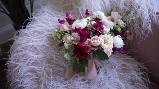 An elegant bridal bouquet from fresh flowers of roses and peonies, white, burgundy and pink shades. Details luxury wedding. Florist shop.