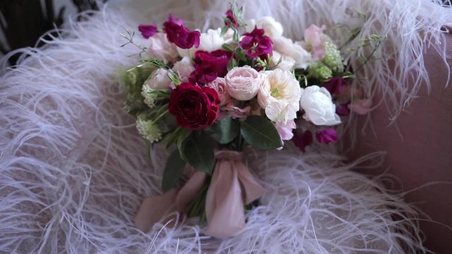 An elegant bridal bouquet from fresh flowers of roses and peonies, white, burgundy and pink shades. Details luxury wedding. Florist shop.