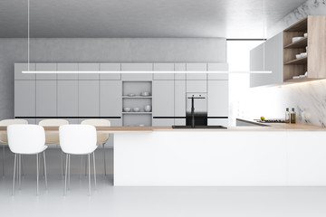 White marble kitchen with countertops and chairs