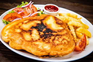 Fried pork chop with french fries and vegetable salad