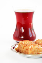 traditional national Turkish sweetness baklava on decorative plate and a glass of tea