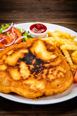 Fried pork chop with french fries and vegetable salad