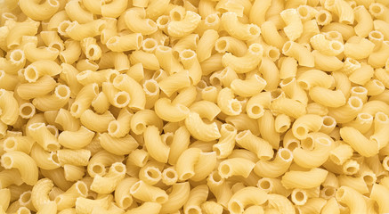 Horns pasta in in quantities - macaroni texture