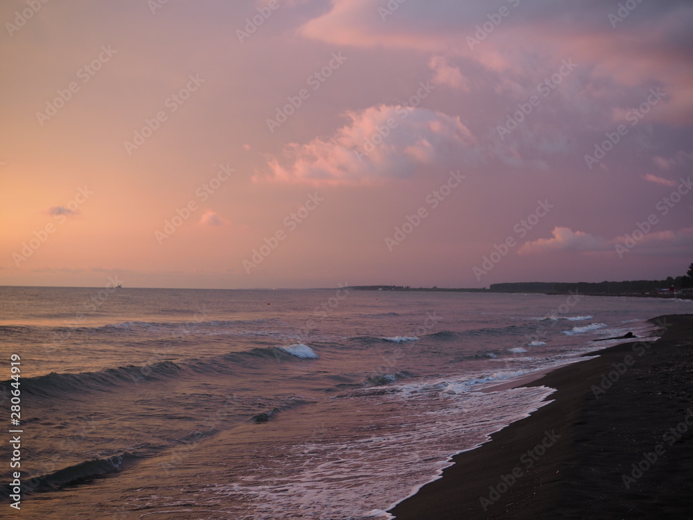 Wall mural picturesque pink sunset on lake beach sea sand beautiful colors in the sky clouds