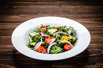 Greek salad on wooden background