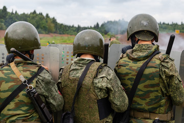 Fototapeta premium Military police behind a wall of shields