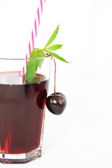 cherry berry and glass with fruit juice with mint leaves