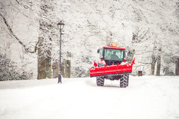 tractor cleans road from snow in the winter