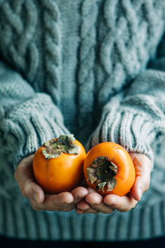 Woman With Ripe Persimmom In Her Hands