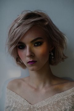 Fashionable girl in dark room with tender light