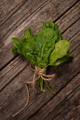 bunch of spinach on wooden background Top view
