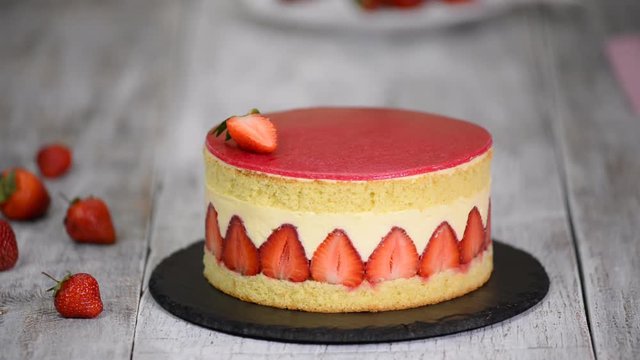 Strawberry cake. Fraisier cake on wooden background.