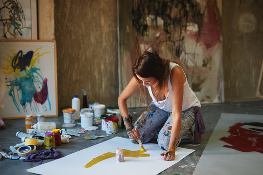 Young woman painting.