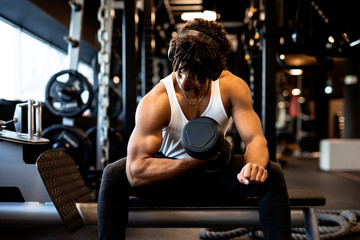 Young afro man training in the gym