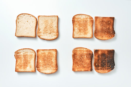 Set of fresh, fried pieces of toast bread on a gray background with copy space. Food pattern. Flat lay