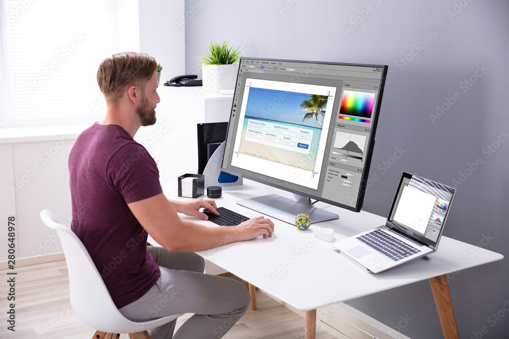 Poster Designer Editing Photo On Computer