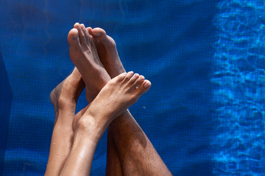 Couple's feet in water