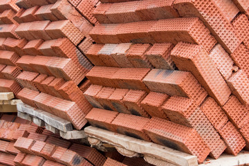 Obraz na płótnie Canvas New red clay bricks for masonry building walls. Material for the construction of a new building.