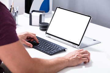 Hand Pointing At Laptop With White Blank Screen