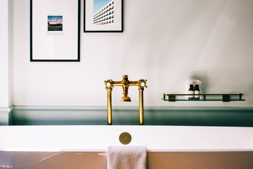 Beautiful Deluxe Bathroom Detail With Framed Photos Above Bathtub