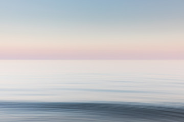 A soft blue and pink blurred seascape