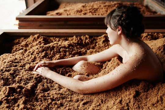 Woman soaking in fermented Japanese cedar enzyme bath at spa