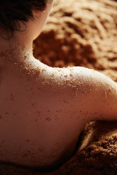 Close up of woman relaxing in cedar enzyme bath in spa