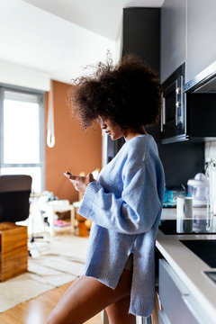 Beautiful afro woman using the mobile