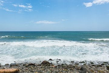 Fototapeta na wymiar Waves crashing on shore on a tropical beach