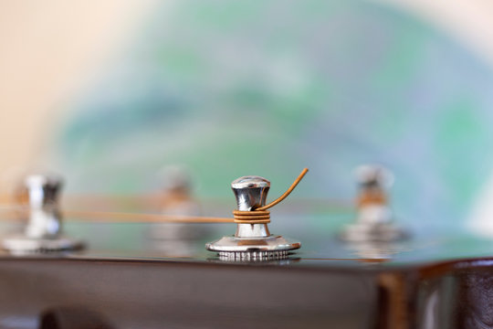 Guitar string in a tuning peg.