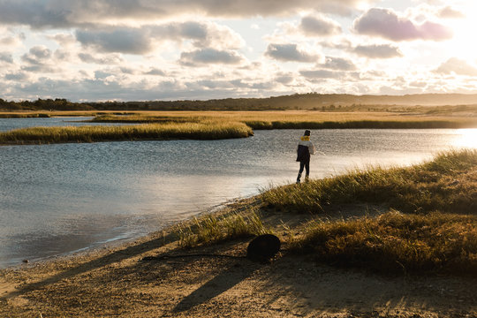 teen boy fishing at sunset