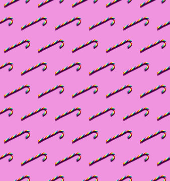 Rainbow-colored Candy Canes On A Magenta Background