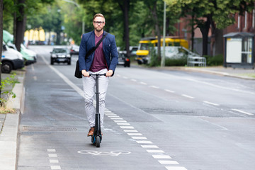 Fototapeta premium Young Businessman Travel With Electric Scooter