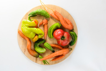 Ugly vegetables on a white background. Ugly food concept, flat lay.