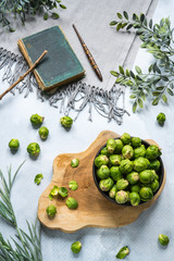 brussels sprouts on  black plate and vintage book